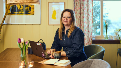 Bildet viser Marianne Mørck Danielsen som sitter og jobber foran en PC.
