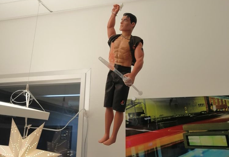 mr.vid19 Bildet viser Paul Jefferson i form av Action Man, som henger i taket på korttidsposten på Haukeland universitetssjukehus.