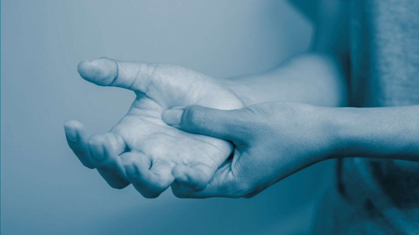 Painful hands The photo shows two hands, one rubbind the other to signify pain