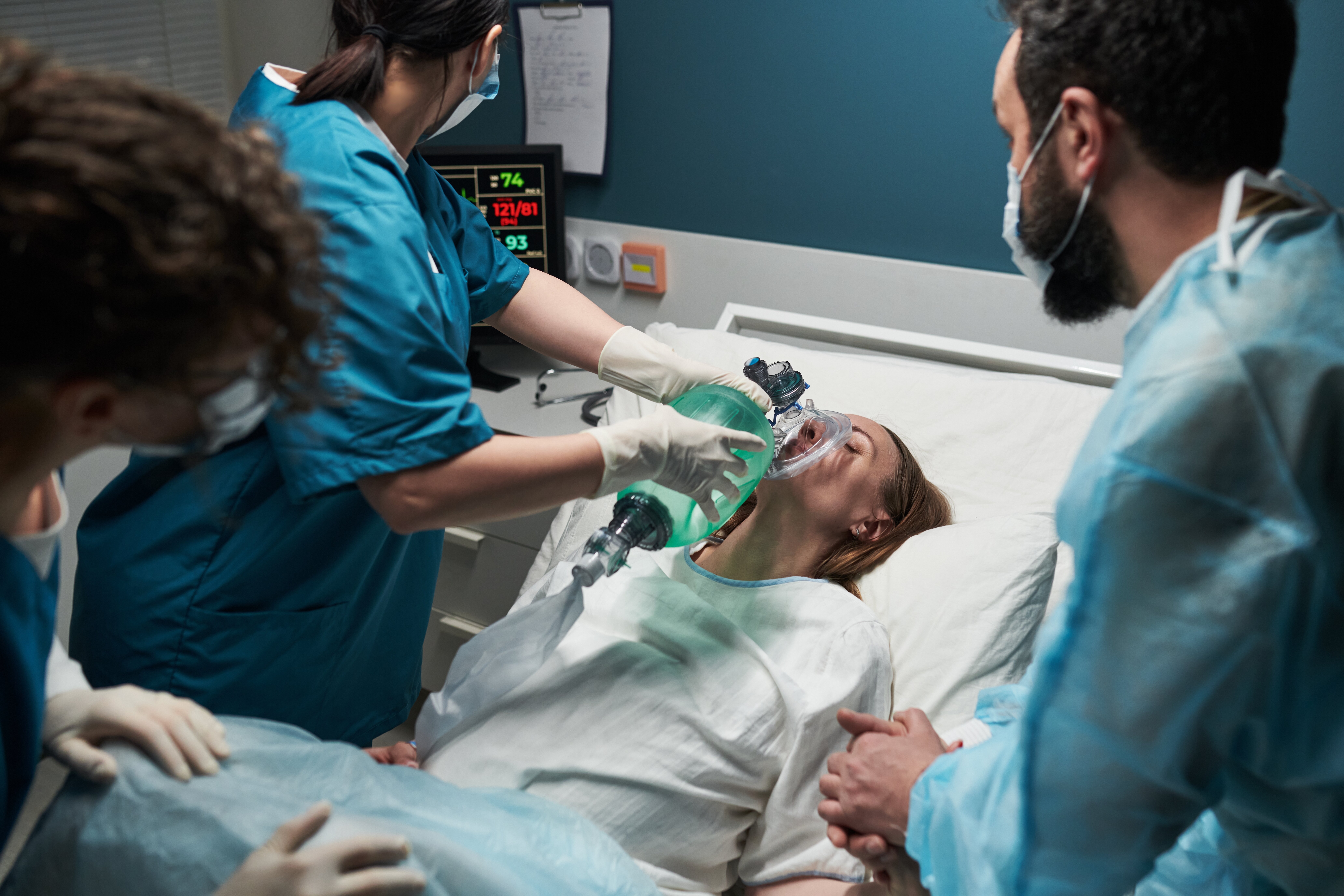 Trauma care The image shows a trauma patient being ventilated by a nurse on the trauma team. Several other nurses are standing around the patient's bed.