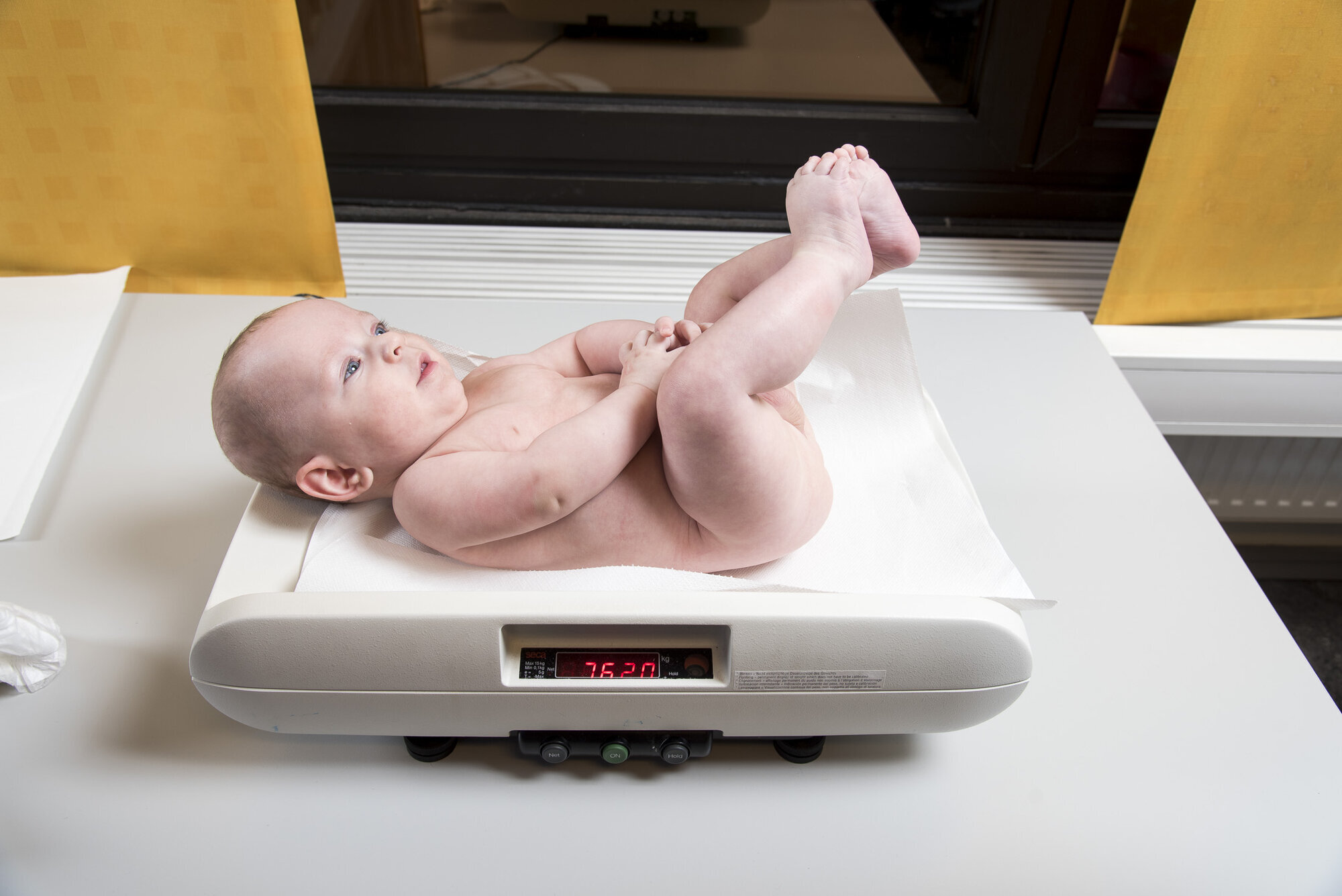 Baby veies Bildet viser en baby som blir veid på helsestasjonen.